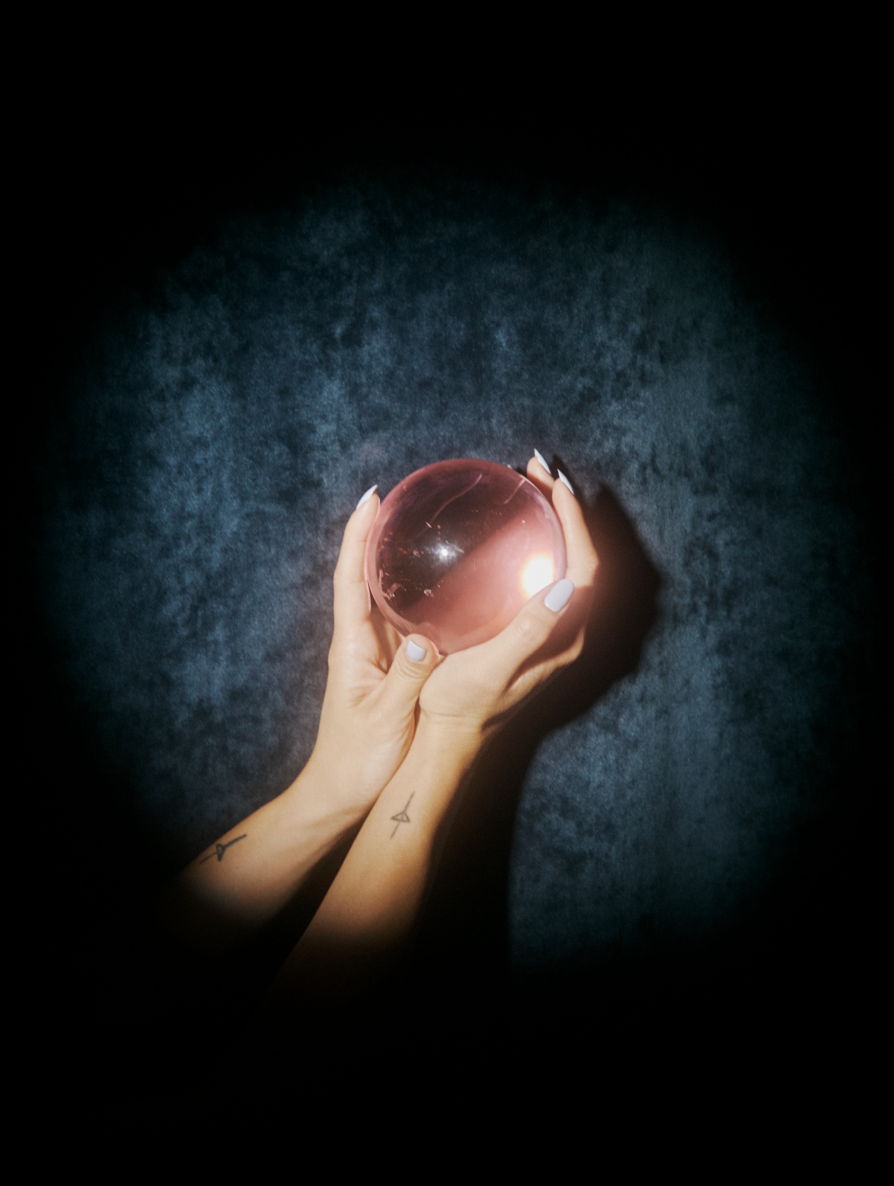 Two hands cradling a translucent sphere — anticipating the next move
